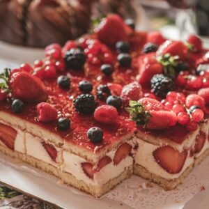 Enticing layered cake topped with fresh berries, perfect for food lovers.